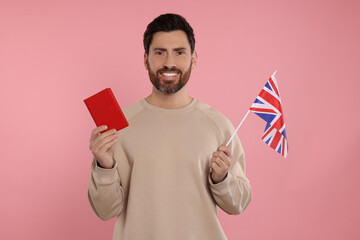 Immigration. Happy man with passport and flag of United Kingdom on pink background