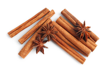 Aromatic cinnamon sticks and anise stars isolated on white, top view