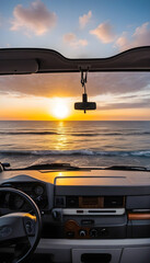 Sunset in front of the sea from inside a van