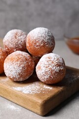 Delicious sweet buns with powdered sugar on table, closeup