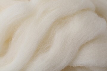 White felting wool as background, closeup view
