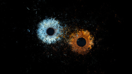Galaxy explosion effect of human eyes colliding on black background. Close-up of blue and brown...