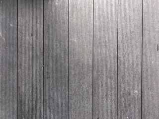 Abstract design with a mix of light and dark wooden planks forming a unique pattern.