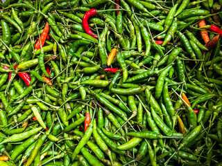 Backdrop of green chilli peppers texture background. Close up view with copy space for design
