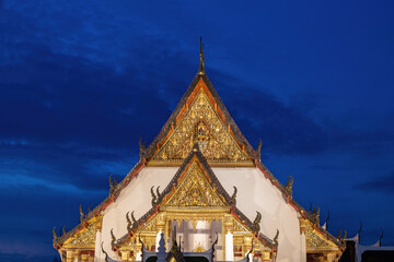 Front façade of Wat Suthat temple in Bangkok, Thailand. Royal Temple constructed in 1807.  Gold...