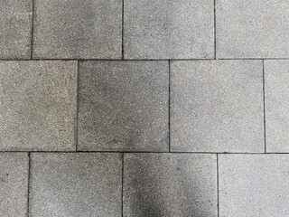 The abstract patterns on the rough wall create a visually interesting composition.