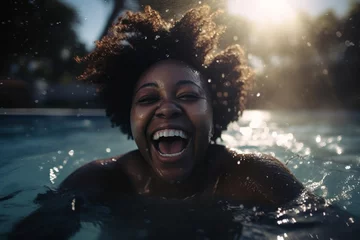 Foto op Plexiglas african american woman swiming in the pool at summer, happy black person having fun on vacation laughing and splashing cheerfully coming out of the water © Alan