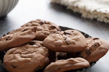 Close up of delicious chocolate chip cookies set on background