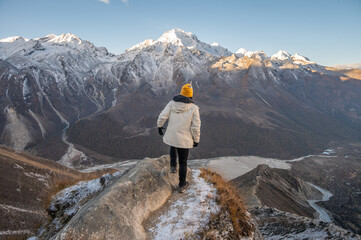 Rear view of female tourist while climbing on Tsergo Ri (4,990m) the high point on the Langtang...