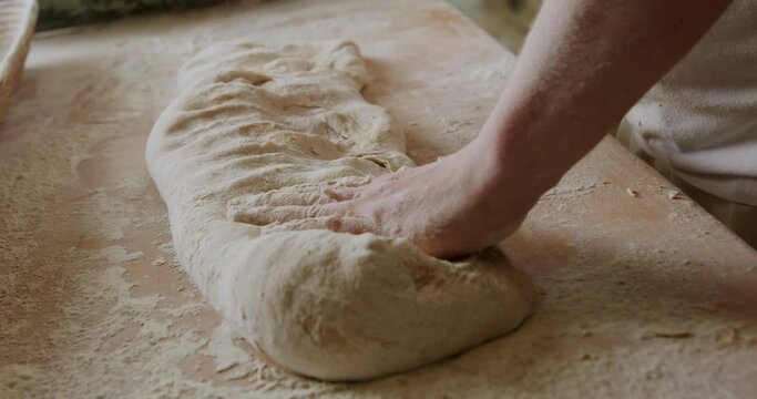 Baker making sourdough bread 4K, the process of making bread dough, healthy home-made breakfasts, bakery and pastries, production of healthy food, traditional regional specialties.