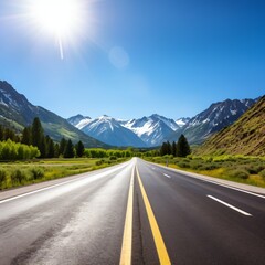 Fototapeta premium Scenic view of an empty asphalt road through snow-capped mountains