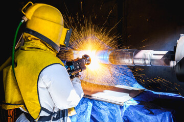 Technician operator repair outside diameter shaft gear by wire arc spraying fusion stainless steel...