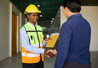 worker taking money from employer in the factory