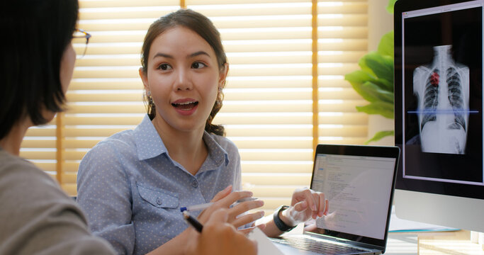 Big data AI coding screen for asian future health care smart tech IT solution. Asia team woman people code analyst job work on science project Lung X-ray scanner medtech tools meeting talk at office.