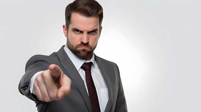 businessman pointing his finger to a camera with serious angry face, isolated on white background.