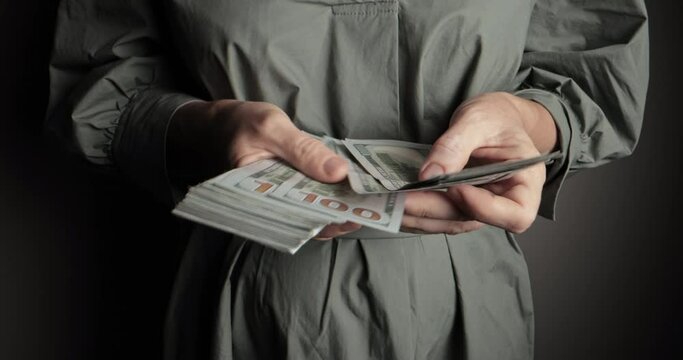 In background, men's hands count stacks of hundred dollar bills. Effective budgeting and financial planning. Successful money management. Close-up of counting money. American currency management.