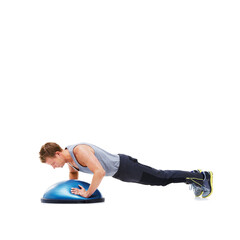 Fototapeta premium Man, training and half ball for plank in studio for fitness, strong exercise and gym with muscle health on floor. Bodybuilder or young sports model with push up or arms workout on a white background