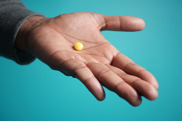 Close up of man hand holding pills with copy space 