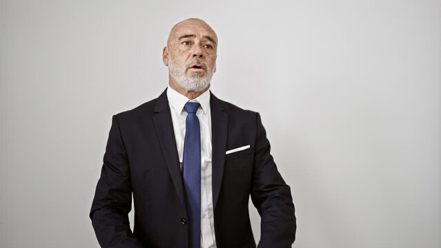 Mature bearded man in suit posing confidently against a white background, conveying a professional business appearance.