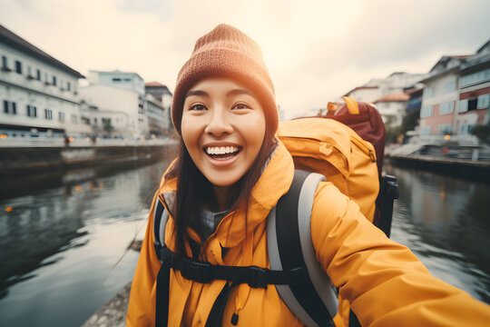 Happy traveller Asian teen with backpack taking selfie picture - Travel blogger Life style and technology concept