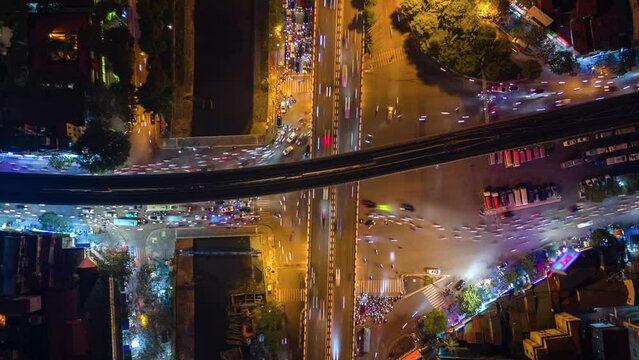 Aerial time-lapse of evening traffic at an intersection in Hanoi, Vietnam.