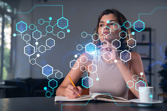Smiling woman in casual wear taking notes in notebook at office workplace with coffee cup. Concept of distant business education, information technology, dreaming, thinking. Blockchain drawings