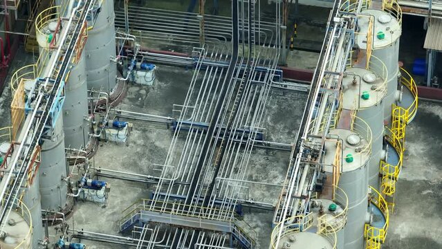 The industrial landscape, a lubricant plant hums with activity. It churns out oils and greases, filling the air with the scent of petroleum. Technology and fluid concept. Aerial footage. 4K.
