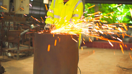 Professional heavy industry workers wearing safety suits using angle grinders and metal pipe cutters.