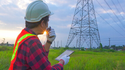 Engineering in standard safety uniform working inspect the electricity high voltage pole with...