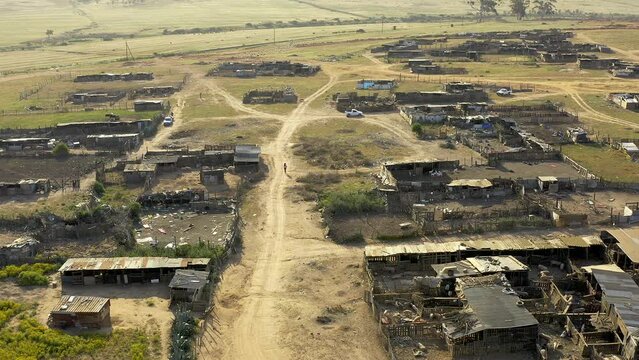 Drone, shack in township and landscape of informal settlement or shanty town, infrastructure and poverty. Roof of houses, aerial view of environment and land in poor or rural area with road or path