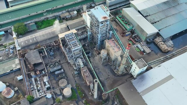 From a bird's-eye view, a paper and packaging factory's exterior reveals a symphony of machinery in motion. The hum of activity is a testament to the industry's productivity. Aerial footage.
