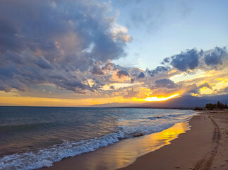 Colorful sunset on the sea. Mountain lake in the rays of the orange sun. Kyrgyzstan, Lake Issyk-Kul. natural background