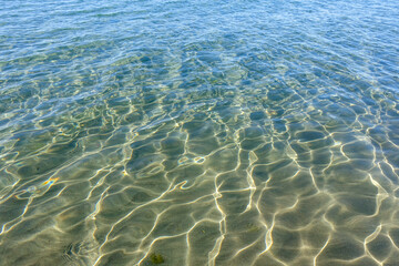 Clean transparent sea water, lake bottom and sand. Beautiful blue, turquoise transparent surface