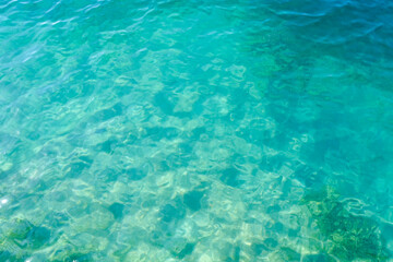 Clean transparent sea water, lake bottom and sand. Beautiful blue, turquoise transparent surface