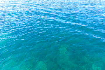 Obraz premium Clean transparent sea water, lake bottom and sand. Beautiful blue, turquoise transparent surface