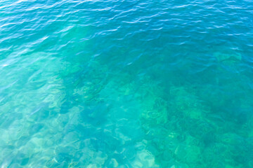 Clean transparent sea water, lake bottom and sand. Beautiful blue, turquoise transparent surface