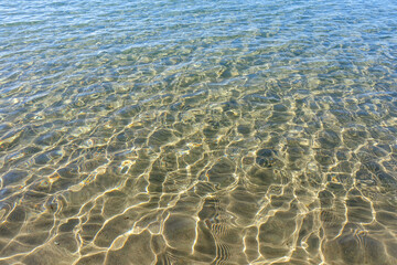 Clean transparent sea water, lake bottom and sand. Beautiful blue, turquoise transparent surface