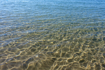 Clean transparent sea water, lake bottom and sand. Beautiful blue, turquoise transparent surface