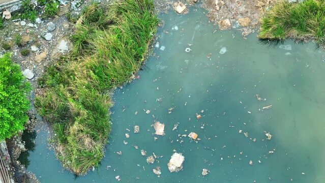 Industrial wastewater is a ticking time bomb, contaminating our precious water sources daily. Immediate action is imperative to prevent irreversible damage. Water pollution and sewage concept. Drone.
