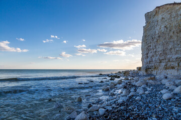 A view over the ocean from the beach at Cuckmere Haven, on a sunny evening
