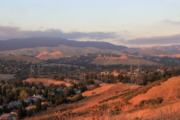 The Marine layer moves in the East Bay as the setting sun lights up the hills in a golden light