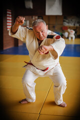 Respected and experienced judo sensei master instructor in traditional gi kimono. A skilled martial artist demonstrates his expertiset