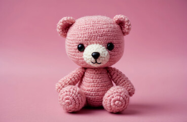 pink knitting teddy bear doll with simple pink background