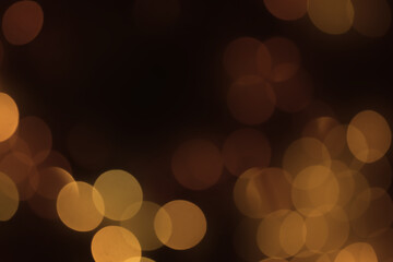 Abstract beautiful blurred gold brown colored bokeh from ornamental lights flickering in the park...