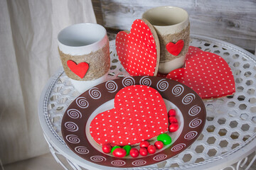 Composition for Valentine's Day. Heart on plate, cup of coffee, gift. Still life composition.Valentine's Day concept. holiday background
