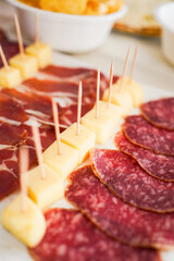 Charcuterie plate with cheese and salami skewers.