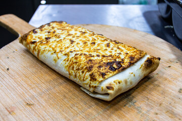 Close-up of taco sandwich on a cutting board.