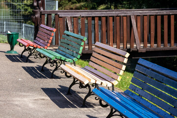 Colorful wooden benches with cast metal legs in the park