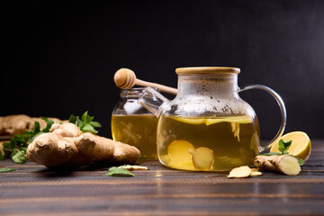 natural organic herbal tea in glass teapot on a wooden table