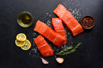 Raw fresh organic trout fillet with ingredients for cooking. Top view with copy space.